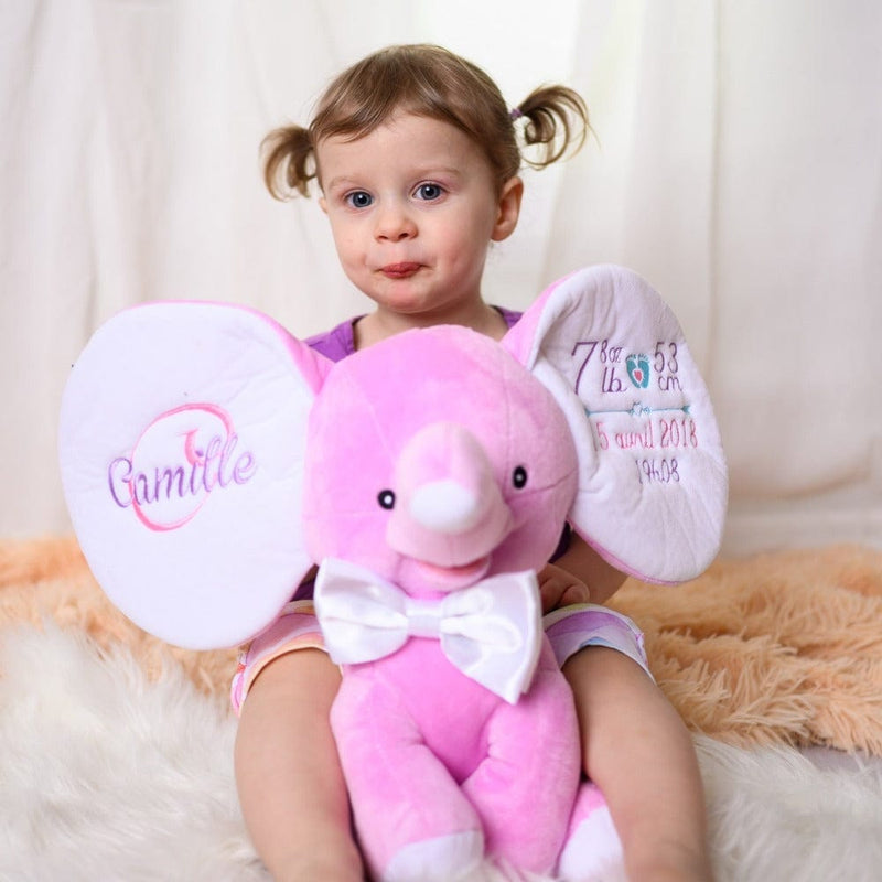 Little girl with her personalized stuffed elephant lavender with name and birth stats