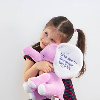 Little girl hugging a personalized stuffed elephant